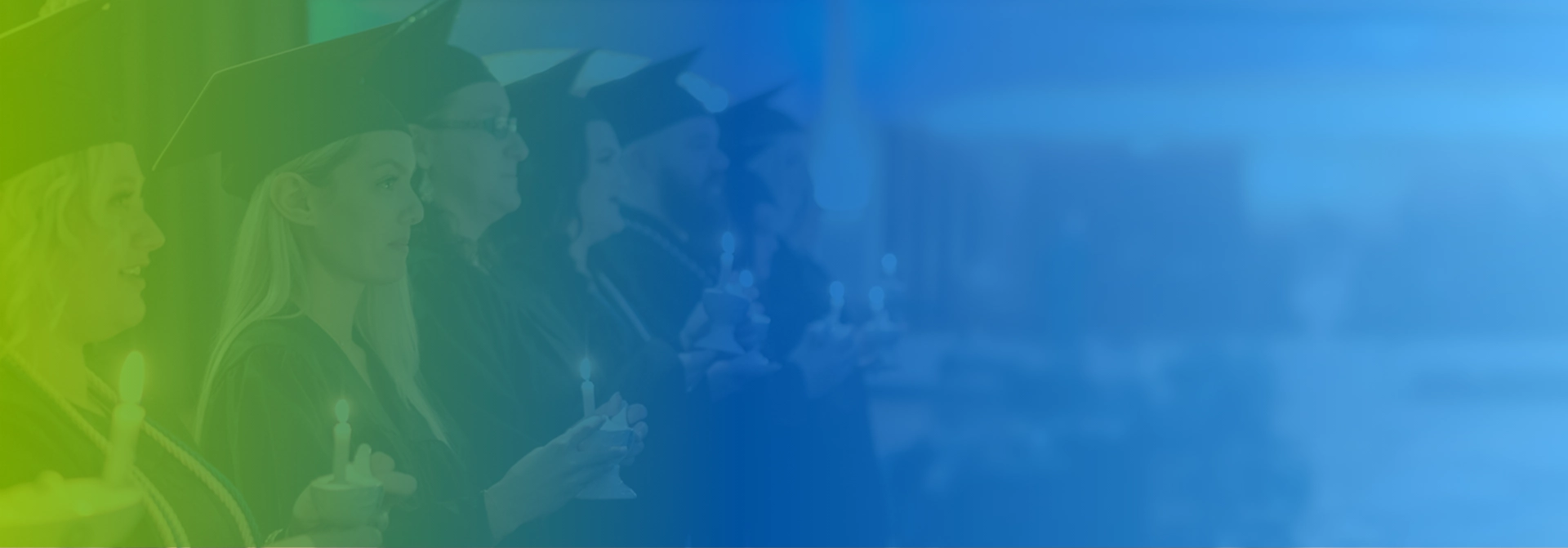 Graduates in caps and gowns holding candles during a ceremony, with a blue and green color overlay.