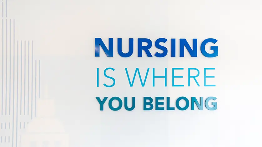 White wall that reads Nursing is Where You Belong.