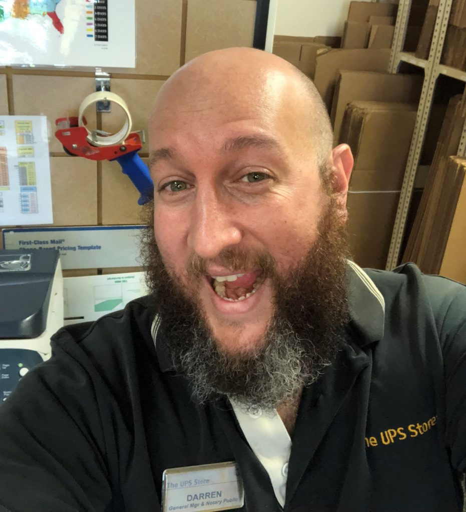 Darren Benari snaps a photo at his UPS store.